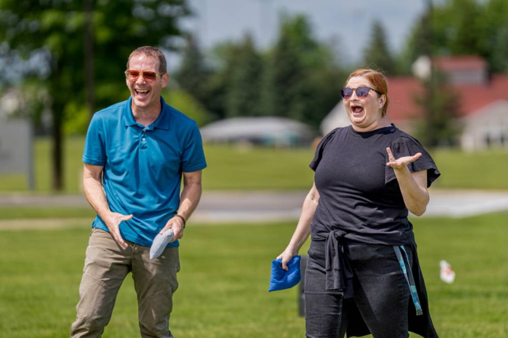 Two players laugh and smile during a game